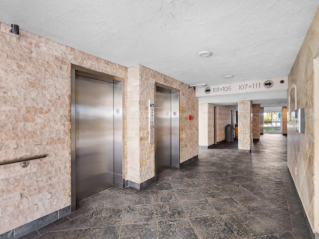6300 Midnight Pass Rd Unit 809, Sarasota, FL 34242 - hallway with elevator and a textured ceiling