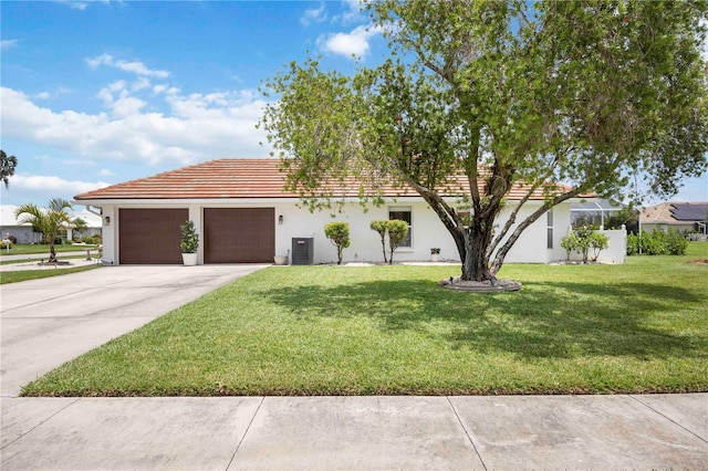 5028 Greenway Ct, North Port, FL 34287 - view of front facade featuring a garage, driveway, a front yard, a tiled roof, and stucco siding