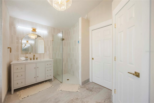5028 Greenway Ct, North Port, FL 34287 - bathroom featuring vanity, a tile shower, and marble finish flooring