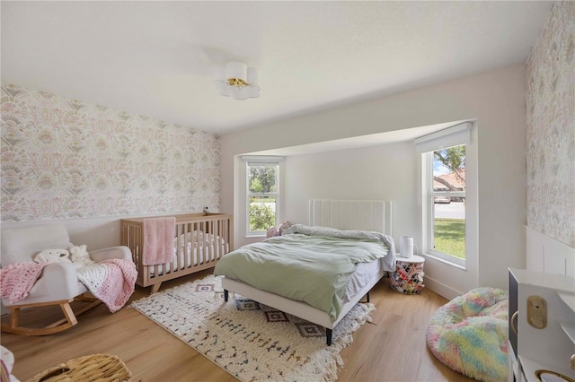 5028 Greenway Ct, North Port, FL 34287 - bedroom featuring wallpapered walls and wood finished floors
