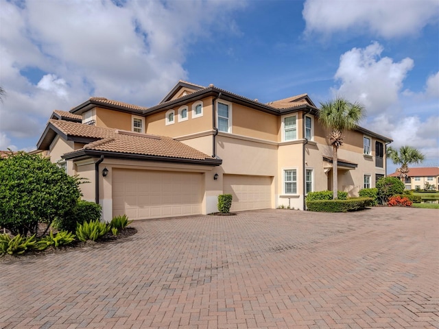 141 Bella Vista Ter Unit 34B, North Venice, FL 34275 - mediterranean / spanish home featuring stucco siding, decorative driveway, and a tiled roof