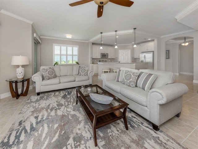 141 Bella Vista Ter Unit 34B, North Venice, FL 34275 - living area featuring light tile patterned floors, crown molding, arched walkways, and a ceiling fan