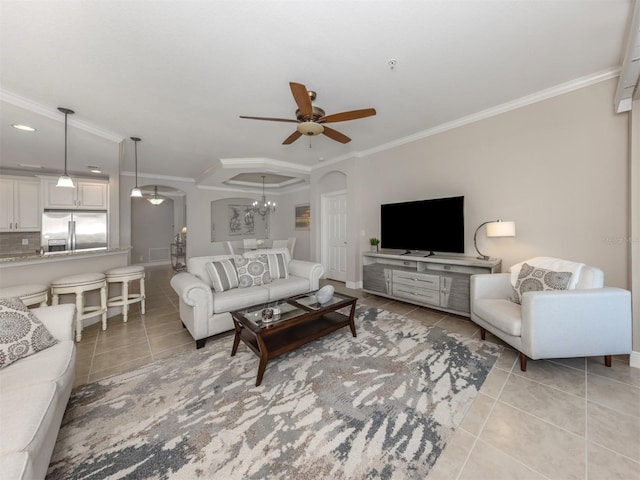 141 Bella Vista Ter Unit 34B, North Venice, FL 34275 - living room featuring light tile patterned floors, a ceiling fan, crown molding, arched walkways, and a chandelier