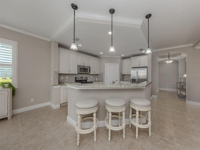 141 Bella Vista Ter Unit 34B, North Venice, FL 34275 - kitchen with appliances with stainless steel finishes, arched walkways, light tile patterned floors, crown molding, and decorative backsplash