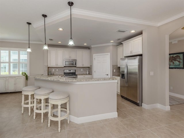 141 Bella Vista Ter Unit 34B, North Venice, FL 34275 - kitchen with stainless steel appliances, a peninsula, tasteful backsplash, light tile patterned flooring, and crown molding