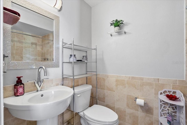 18671 Macgill Ave, Port Charlotte, FL 33948 - bathroom featuring tile walls, a tile shower, and wainscoting