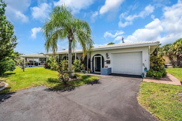 8651 Ellesmere Ct, North Port, FL 34287 - single story home featuring an attached garage, a front yard, driveway, and stucco siding
