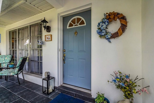 8651 Ellesmere Ct, North Port, FL 34287 - property entrance with covered porch and stucco siding
