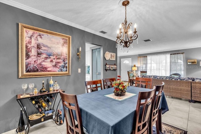 8651 Ellesmere Ct, North Port, FL 34287 - dining space with a chandelier, light tile patterned flooring, crown molding, and a textured ceiling