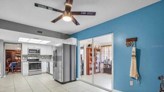 8651 Ellesmere Ct, North Port, FL 34287 - kitchen featuring appliances with stainless steel finishes, white cabinetry, backsplash, light countertops, and a ceiling fan