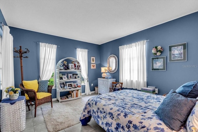 8651 Ellesmere Ct, North Port, FL 34287 - bedroom with tile patterned floors and a textured ceiling