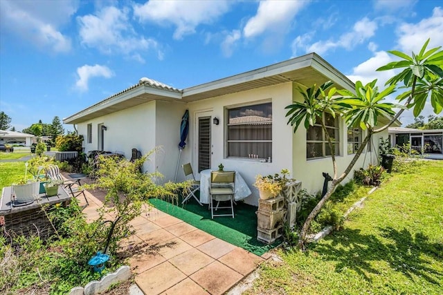 8651 Ellesmere Ct, North Port, FL 34287 - view of front of home featuring stucco siding, a front lawn, and a patio area