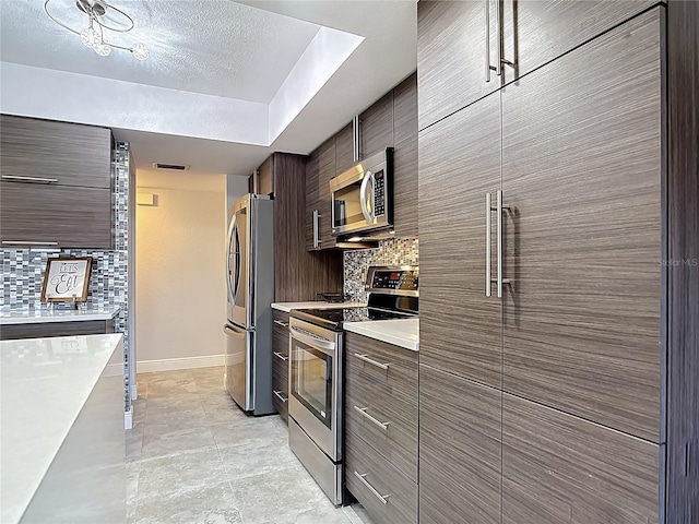 1335 Rock Dove Ct Unit 111, Punta Gorda, FL 33950 - kitchen with appliances with stainless steel finishes, light countertops, backsplash, and modern cabinets