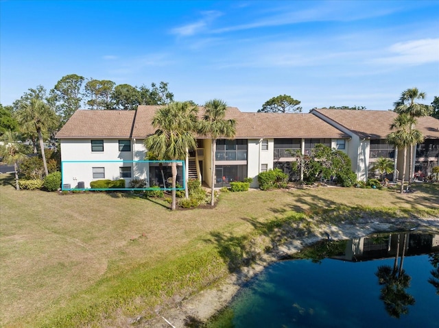 752 White Pine Tree Rd Unit 108, Venice, FL 34285 - back of house featuring a yard, stucco siding, and a water view
