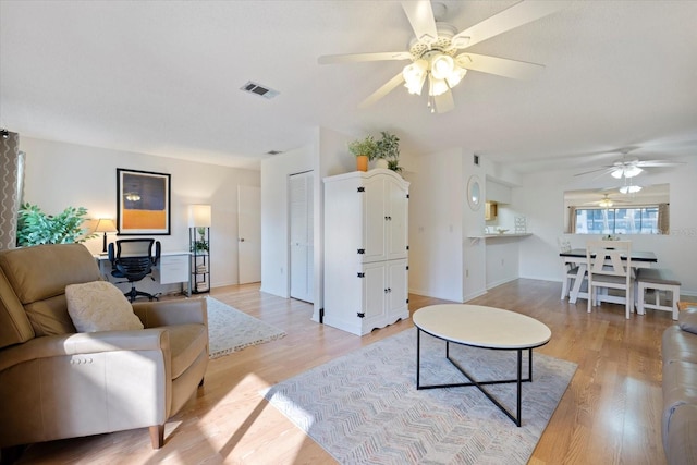 752 White Pine Tree Rd Unit 108, Venice, FL 34285 - living room featuring a ceiling fan and light wood-style flooring