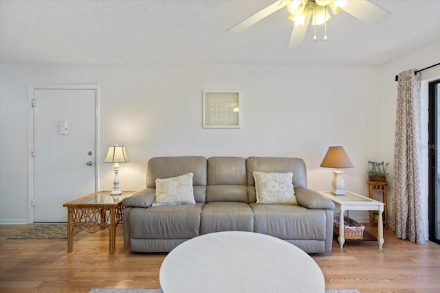 752 White Pine Tree Rd Unit 108, Venice, FL 34285 - living room with ceiling fan, wood finished floors, and a textured ceiling