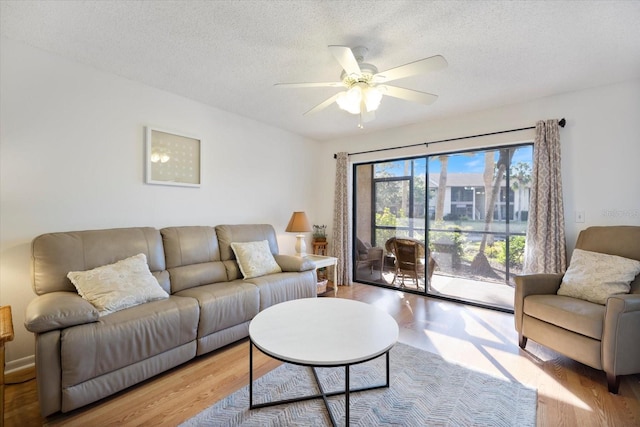 752 White Pine Tree Rd Unit 108, Venice, FL 34285 - living area featuring wood finished floors, ceiling fan, and a textured ceiling