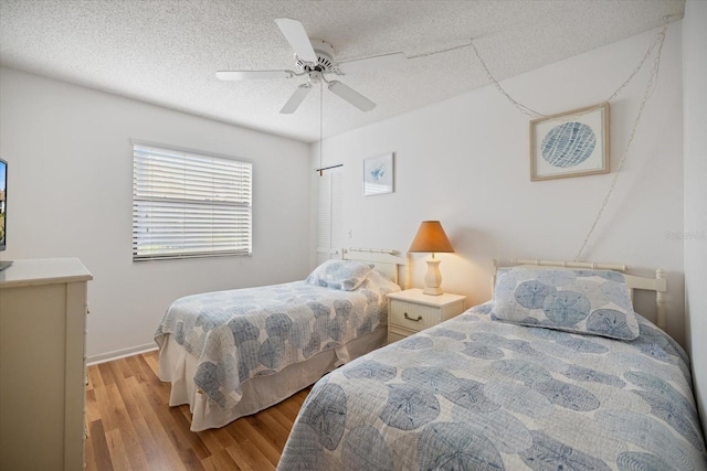 752 White Pine Tree Rd Unit 108, Venice, FL 34285 - bedroom with wood finished floors, a textured ceiling, and ceiling fan