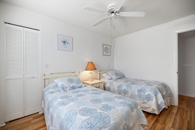 752 White Pine Tree Rd Unit 108, Venice, FL 34285 - bedroom featuring wood finished floors, a closet, ceiling fan, and a textured ceiling