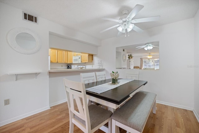 752 White Pine Tree Rd Unit 108, Venice, FL 34285 - dining space with a ceiling fan and light wood-style floors