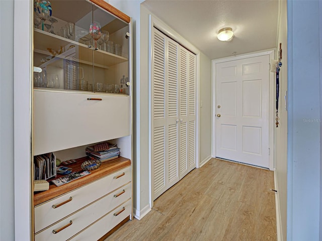 200 The Esplanade N Unit B19, Venice, FL 34285 - hallway with light wood-type flooring and baseboards