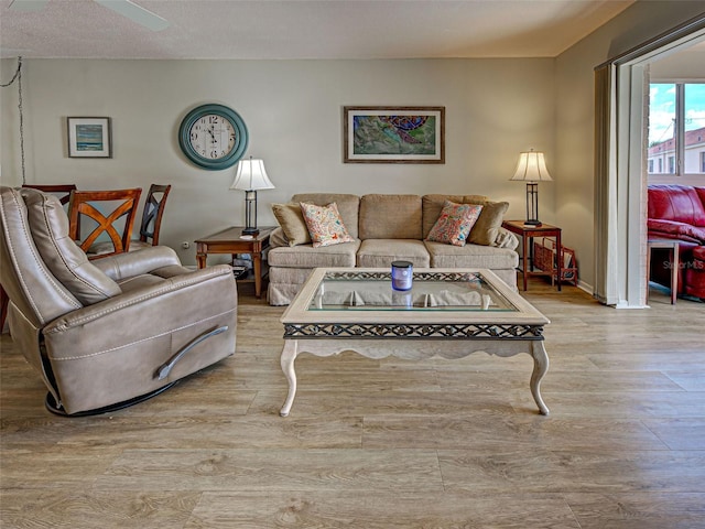 200 The Esplanade N Unit B19, Venice, FL 34285 - living room featuring wood finished floors and baseboards