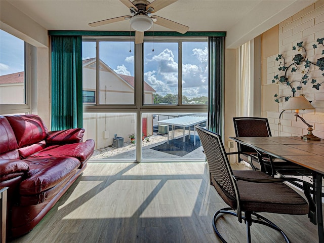 200 The Esplanade N Unit B19, Venice, FL 34285 - sunroom featuring a ceiling fan, plenty of natural light, and outdoor dining area