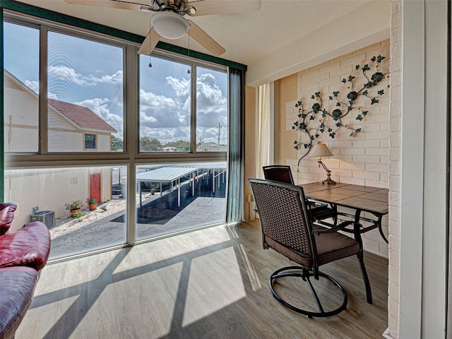 200 The Esplanade N Unit B19, Venice, FL 34285 - sunroom with a ceiling fan and outdoor dining space