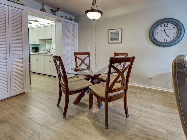 200 The Esplanade N Unit B19, Venice, FL 34285 - dining room featuring light wood-style flooring and baseboards