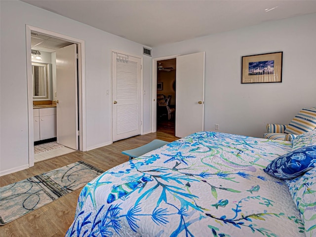 200 The Esplanade N Unit B19, Venice, FL 34285 - bedroom with wood finished floors and connected bathroom