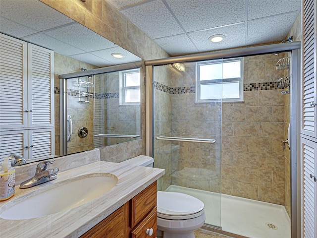 200 The Esplanade N Unit B19, Venice, FL 34285 - full bathroom featuring a stall shower, plenty of natural light, vanity, and a paneled ceiling