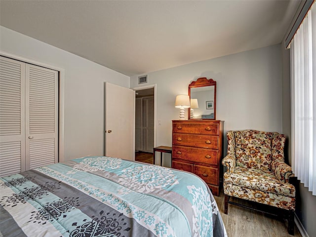 200 The Esplanade N Unit B19, Venice, FL 34285 - bedroom with wood finished floors and a closet