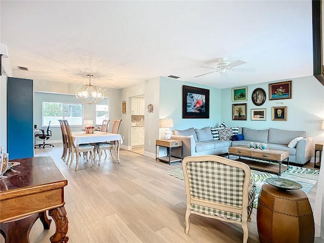 3274 Savage Rd, Sarasota, FL 34231 - living room featuring a chandelier, light wood-type flooring, and a ceiling fan