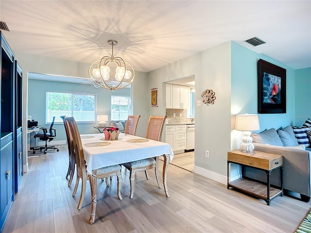 3274 Savage Rd, Sarasota, FL 34231 - dining area featuring light wood-type flooring and a chandelier