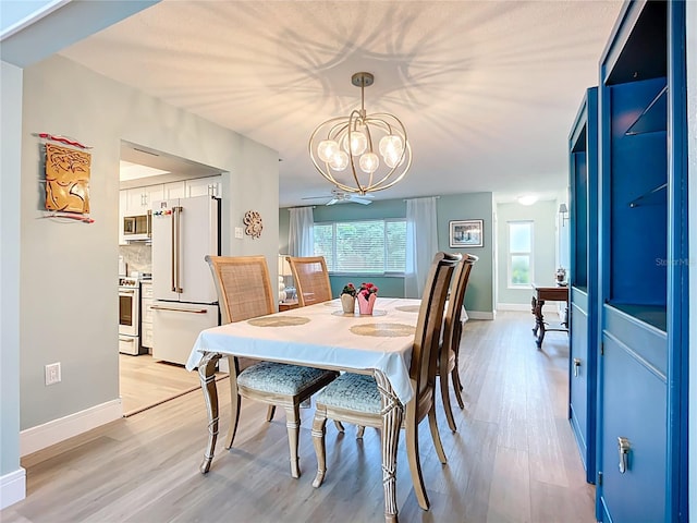 3274 Savage Rd, Sarasota, FL 34231 - dining space with light wood-type flooring and a chandelier