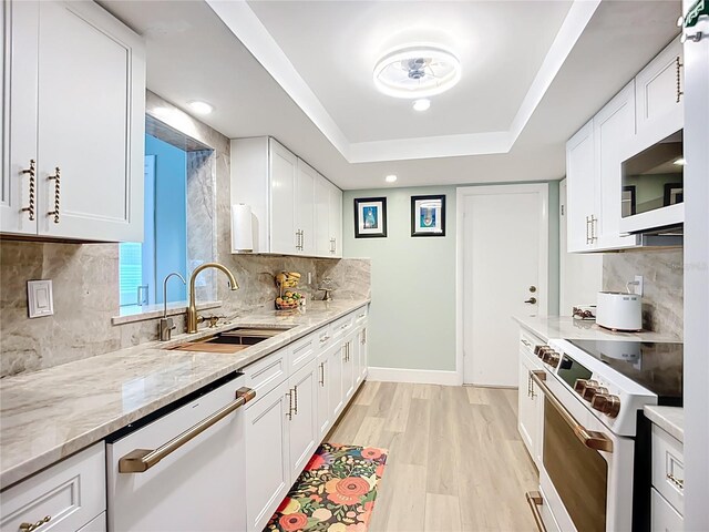 3274 Savage Rd, Sarasota, FL 34231 - kitchen with white appliances, tasteful backsplash, light stone counters, white cabinets, and recessed lighting