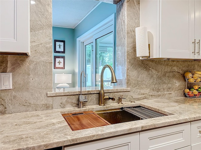 3274 Savage Rd, Sarasota, FL 34231 - kitchen with white cabinets, tasteful backsplash, light countertops, and ornamental molding