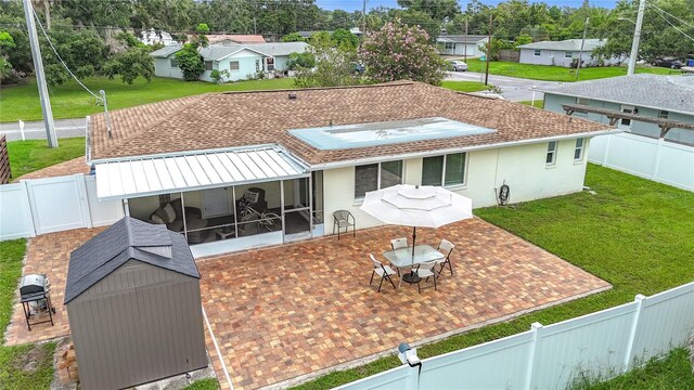 3274 Savage Rd, Sarasota, FL 34231 - back of property featuring a sunroom, a patio, a shed, a fenced backyard, and a residential view