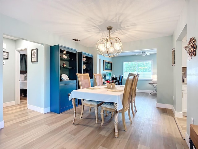 3274 Savage Rd, Sarasota, FL 34231 - dining room featuring light wood finished floors, a chandelier, and a ceiling fan