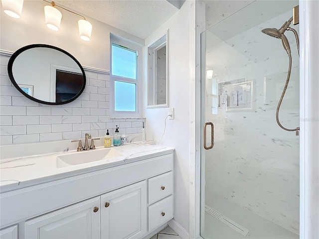 3274 Savage Rd, Sarasota, FL 34231 - full bathroom featuring a marble finish shower, vanity, tasteful backsplash, and a textured ceiling