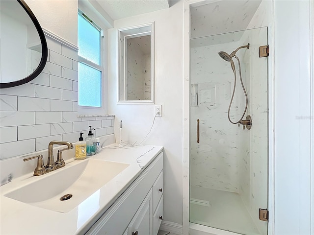 3274 Savage Rd, Sarasota, FL 34231 - bathroom featuring a marble finish shower, vanity, and backsplash