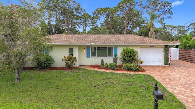 3274 Savage Rd, Sarasota, FL 34231 - ranch-style house featuring an attached garage, decorative driveway, and a shingled roof