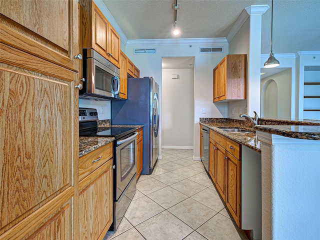 800 San Lino Cir Unit 813, Venice, FL 34292 - kitchen featuring stainless steel appliances, dark stone countertops, rail lighting, ornamental molding, and light tile patterned flooring