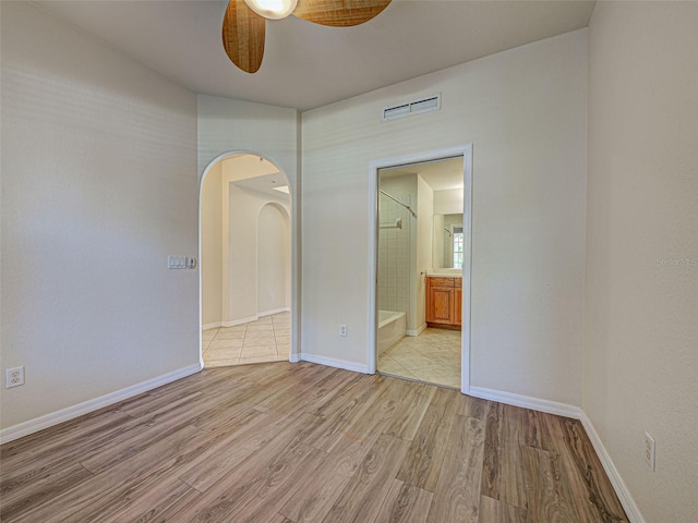 800 San Lino Cir Unit 813, Venice, FL 34292 - unfurnished room featuring a ceiling fan, light wood-style flooring, and arched walkways