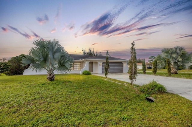 12001 Daroco Ln, North Port, FL 34287 - view of front of house featuring driveway, a garage, a front lawn, and stucco siding