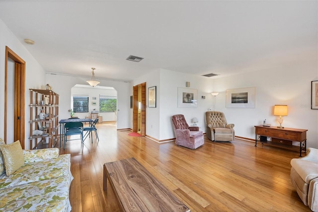 12001 Daroco Ln, North Port, FL 34287 - living room featuring light wood-style flooring and arched walkways