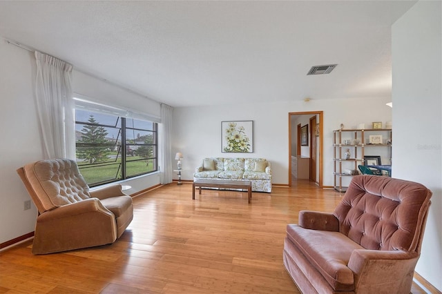 12001 Daroco Ln, North Port, FL 34287 - living area featuring light wood-style flooring and baseboards