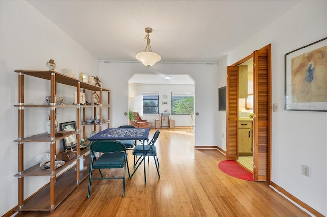 12001 Daroco Ln, North Port, FL 34287 - dining space with light wood-style floors and arched walkways