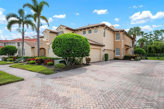 114 Bella Vista Ter Unit 6C, Nokomis, FL 34275 - view of side of home with an attached garage, stucco siding, and driveway