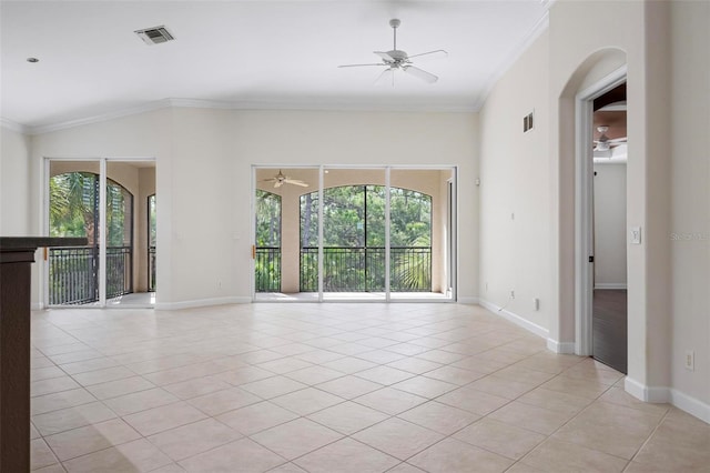 114 Bella Vista Ter Unit 6C, Nokomis, FL 34275 - unfurnished room with ceiling fan, healthy amount of natural light, light tile patterned flooring, ornamental molding, and arched walkways